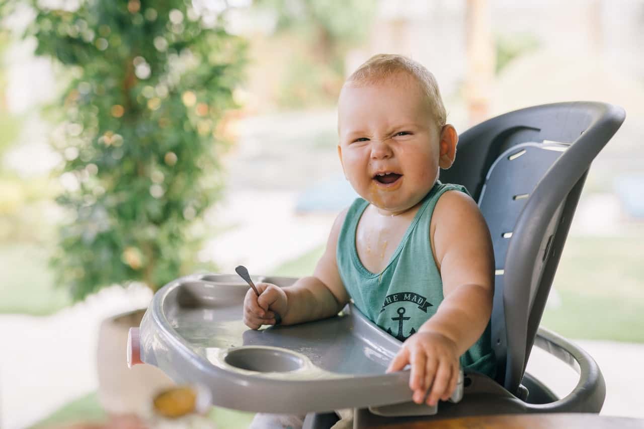 photo-of-baby-sitting-on-high-chair-4669022