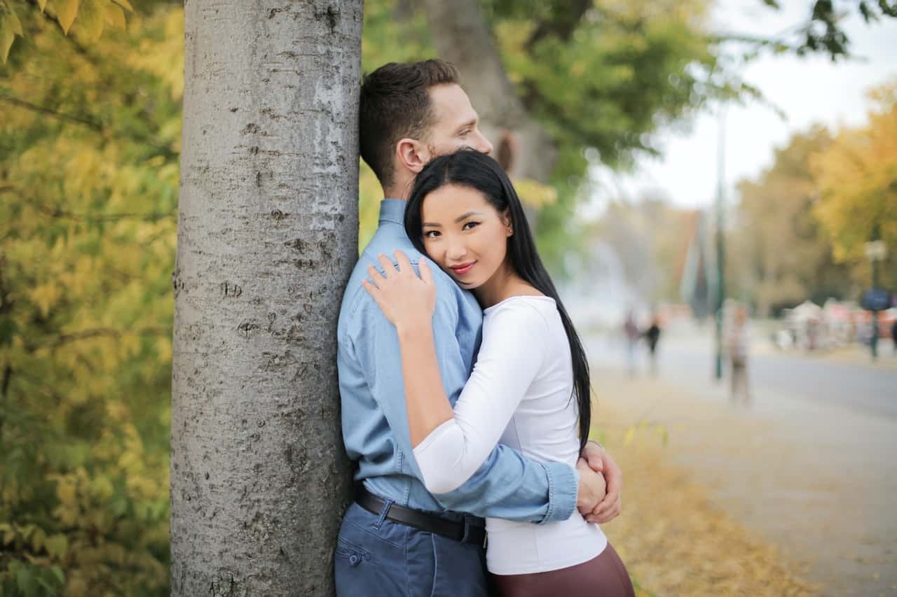 selective-focus-photo-of-hugging-couple-standing-next-to-a-3764200