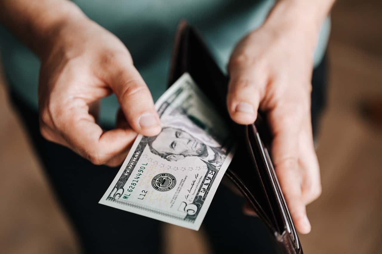 unrecognizable-man-holding-wallet-with-money-4386421