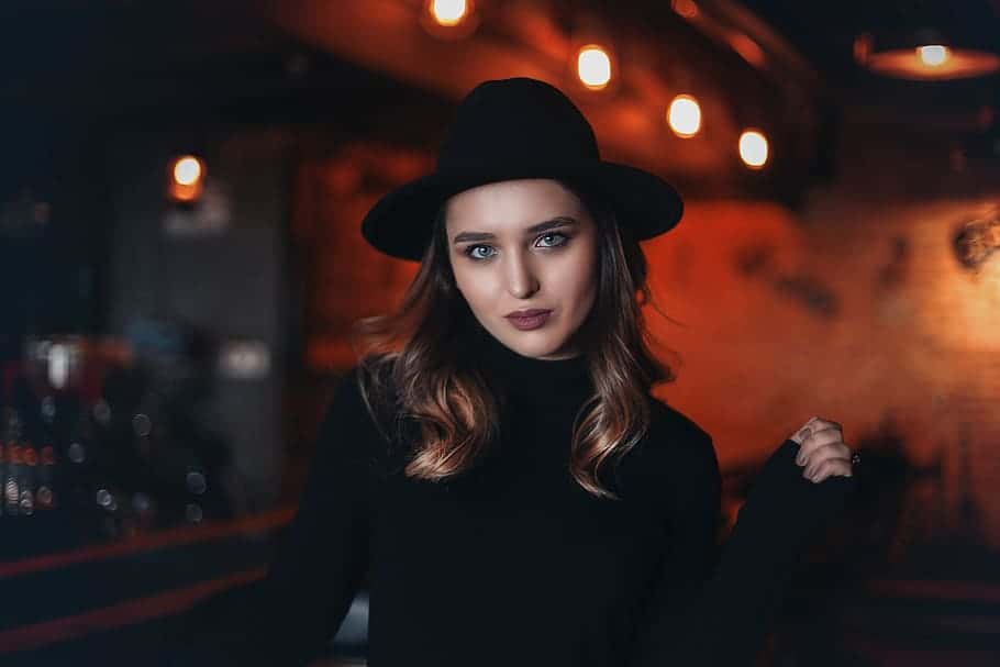woman-in-black-fitted-sweater-inside-bar