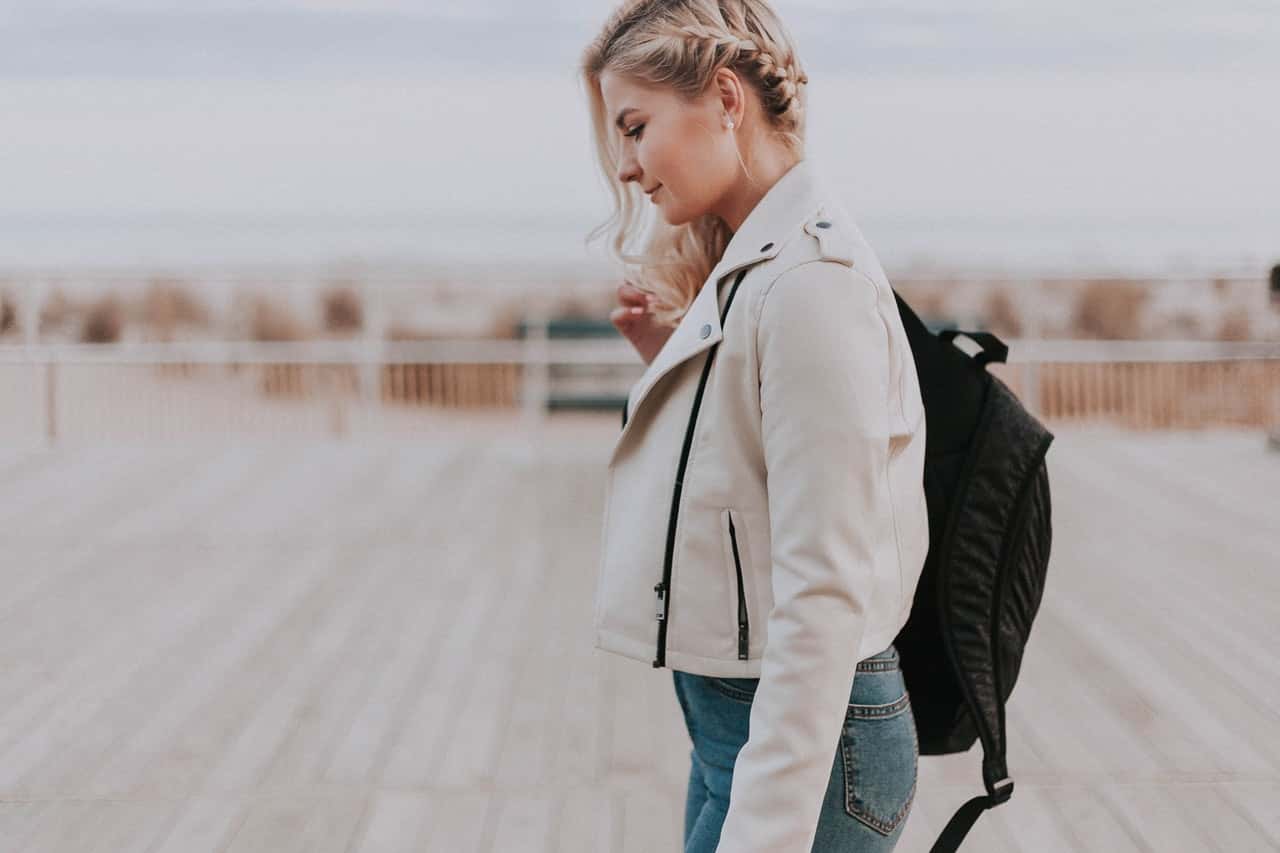 woman-in-black-zip-up-jacket-with-black-backpack-1070970