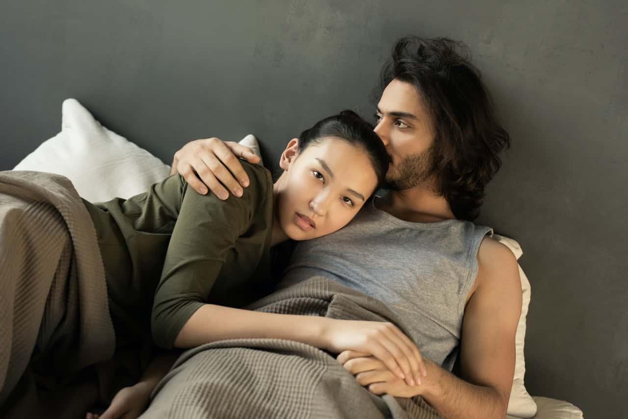 woman-in-green-top-lying-on-a-man-s-chest-in-bed-3754277