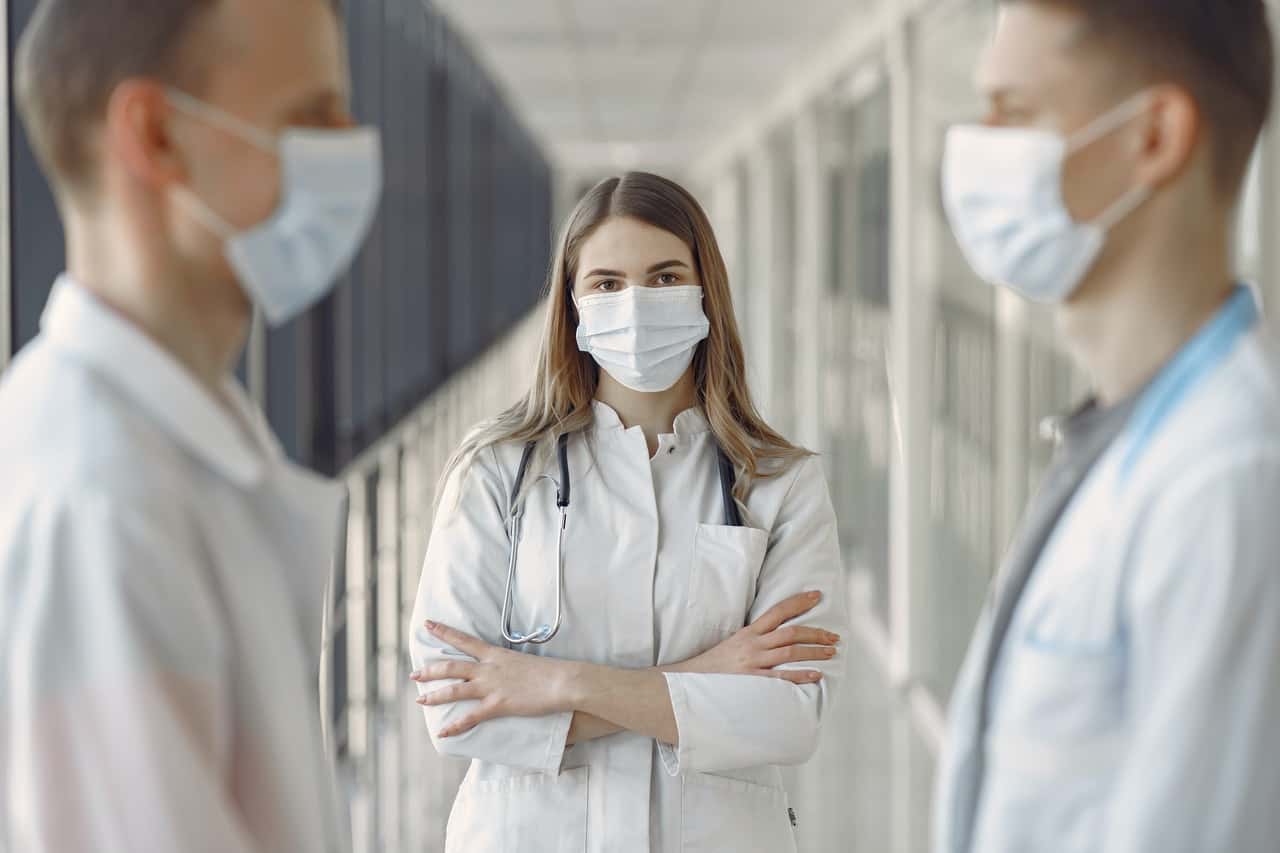 woman-in-white-coat-wearing-white-face-mask-3985163.jpg