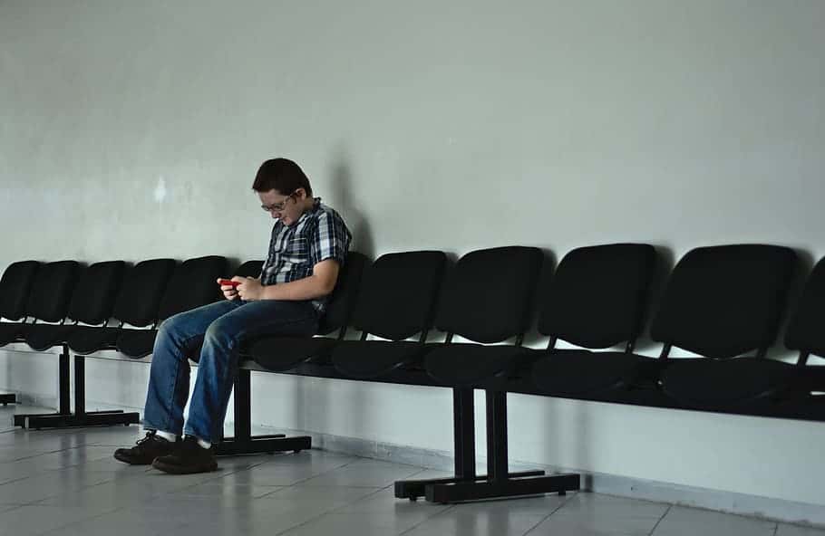 boy-sit-seats-phone-play-white-row