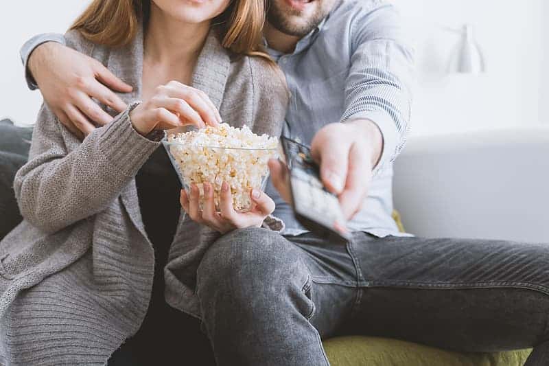 happy-young-couple-relaxing-and-watching-tv-at-home