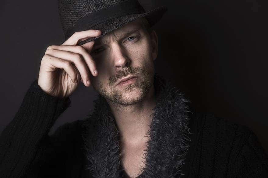 man-serious-face-thinking-expression-hat-black-shadow-adult