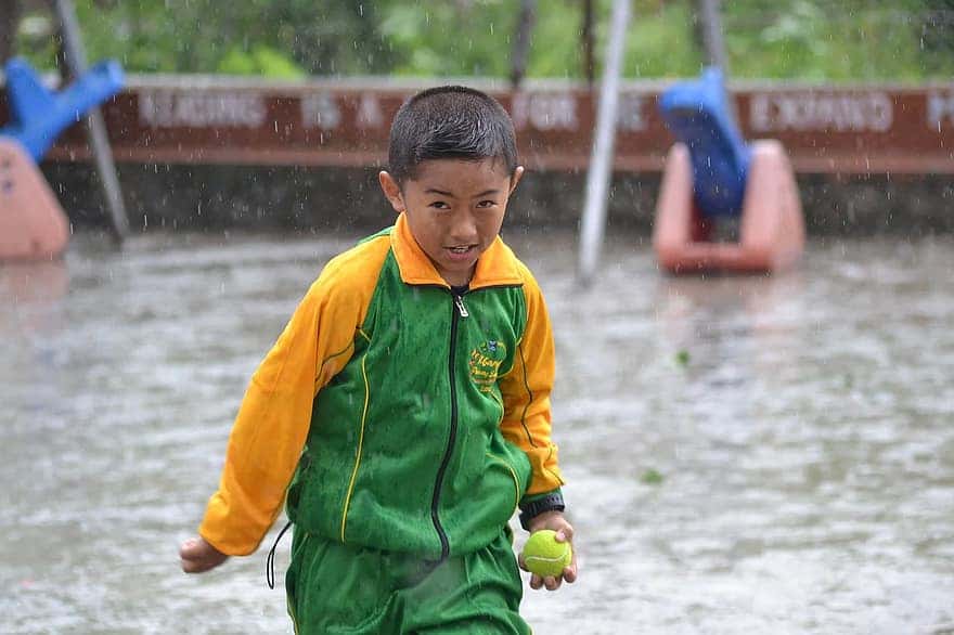 school-boy-playing-rain-ball-asian-bhutan-bhutanese-asia